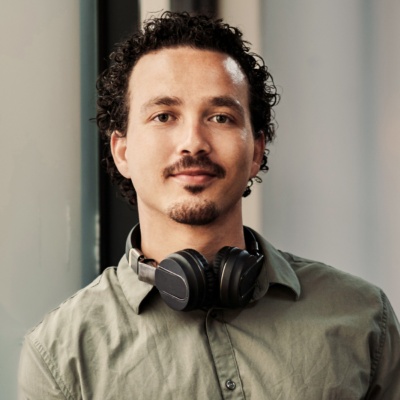 Person looking into camera with headphones on