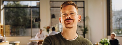 Person with glasses looking into camera