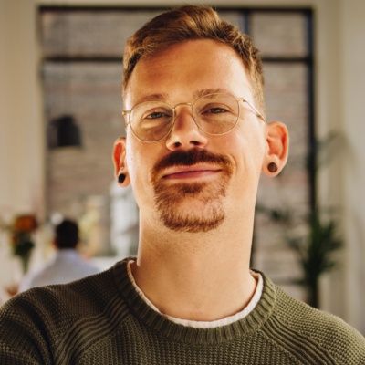 Person with glasses looking into camera