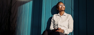 Person with glasses smiling upward