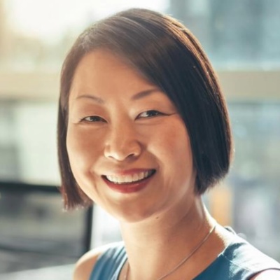 Two people sitting at a conference table in an office.