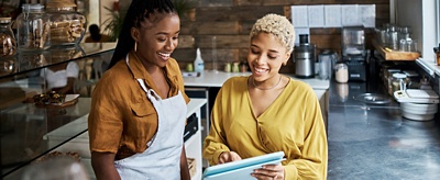 Two employees working at a coffee shop.