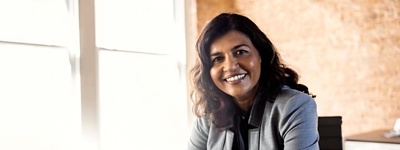 CIO sitting at desk next to notepad and laptop.