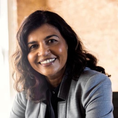 CIO sitting at desk next to notepad and laptop.