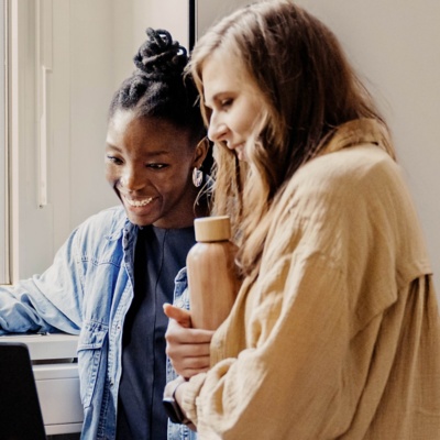 Student showing his colleagues something on laptop