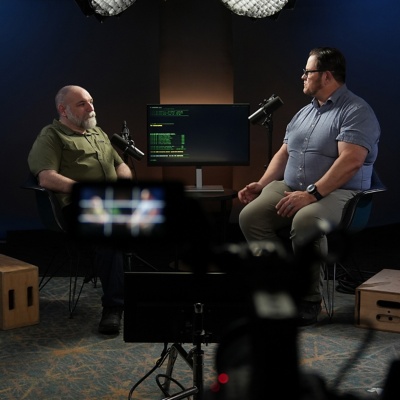 Image shows Workday Extend developers Chris Humphrey and Clint Harwood, from Strada, in conversation.