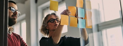 two people collaborating using sticky notes