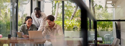 Three people in an office looking at a computer