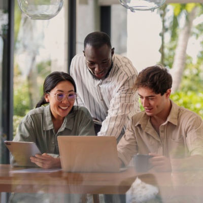 Three people in an office looking at a computer