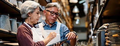 Two small business workers looking at a tablet.