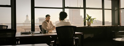 two people sitting at a conference table