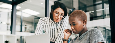 Two women looking at laptop