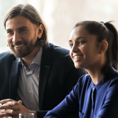 Group of office workers gathered around a conference room table.