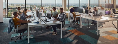 Large group of programmers working in a modern office of a software company. 