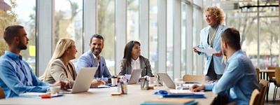 A group of business colleagues talking around a table in a conference room