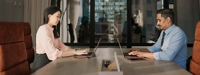 Woman and man sitting across from each other in office