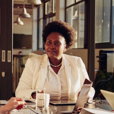 Woman at head of table in meeting
