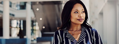 Woman in striped shirt smirking looking to side