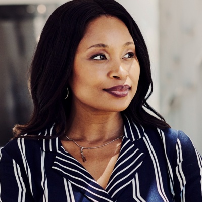 Woman in striped shirt smirking looking to side