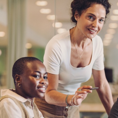 Woman pointing with colleagues at meeting
