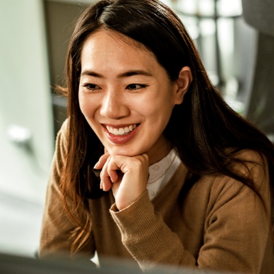 Woman resting head on her hands sitting next to coworker