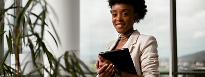 Woman smiling holding tablet