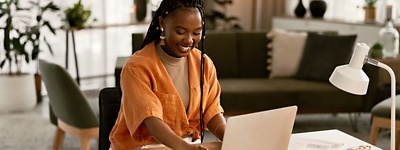 Woman smiling looking at laptop