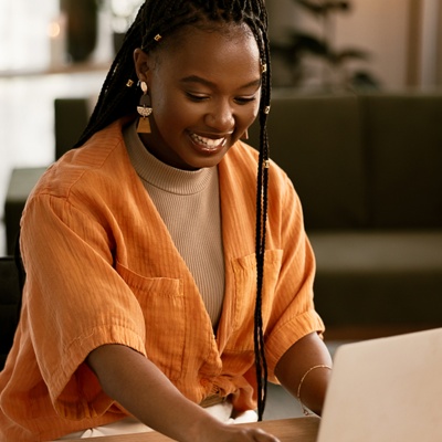 Woman smiling looking at laptop