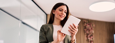 Woman smiling looking down at tablet