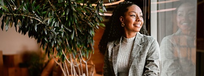 Woman smiling looking through window