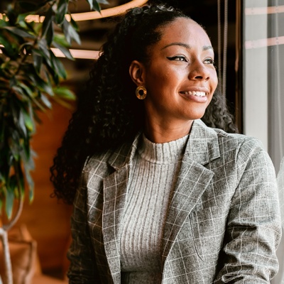 Woman smiling looking through window