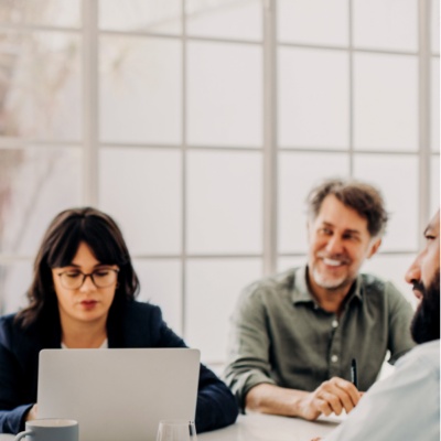 Woman smiling with group of coworkers