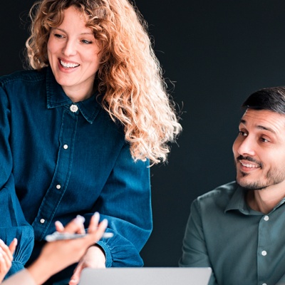 Woman standing up talking to colleagues