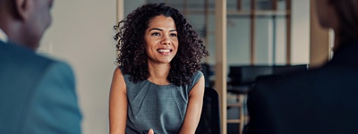 A woman talking to her two colleagues