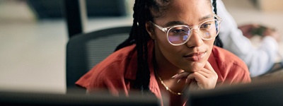 Woman with glasses looking at computer