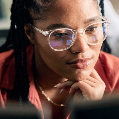 Woman with glasses looking at computer