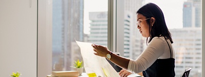 Woman with glasses looking at sheet