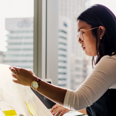 Woman with glasses looking at sheet