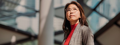 Woman with glasses looking up