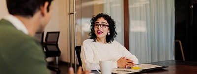 Woman with glasses talking and smiling