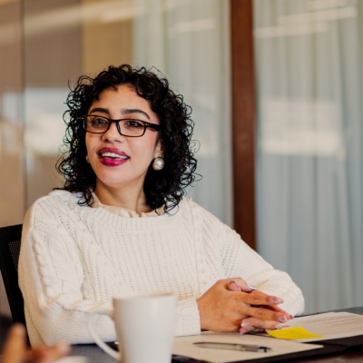 Woman with glasses talking and smiling