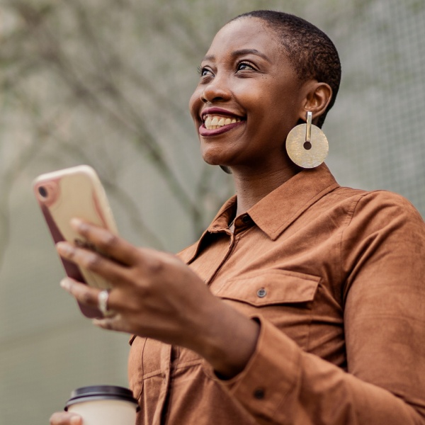 Woman with phone smiling up