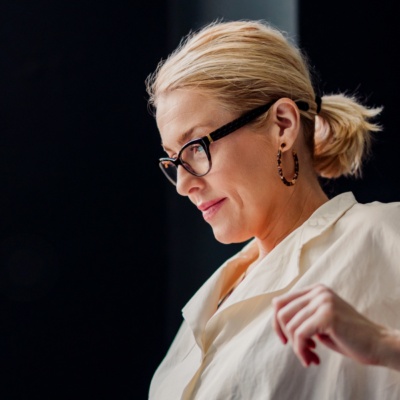 Woman with ponytail looking at laptop