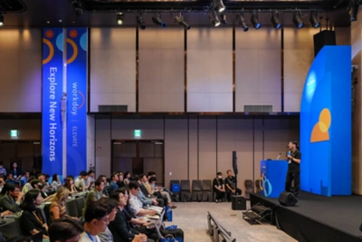 Attendees looking at board