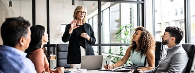 Colleagues in a conference room listening to a presentation 