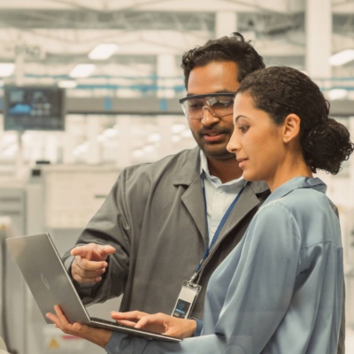 Two colleagues in lab working on laptop